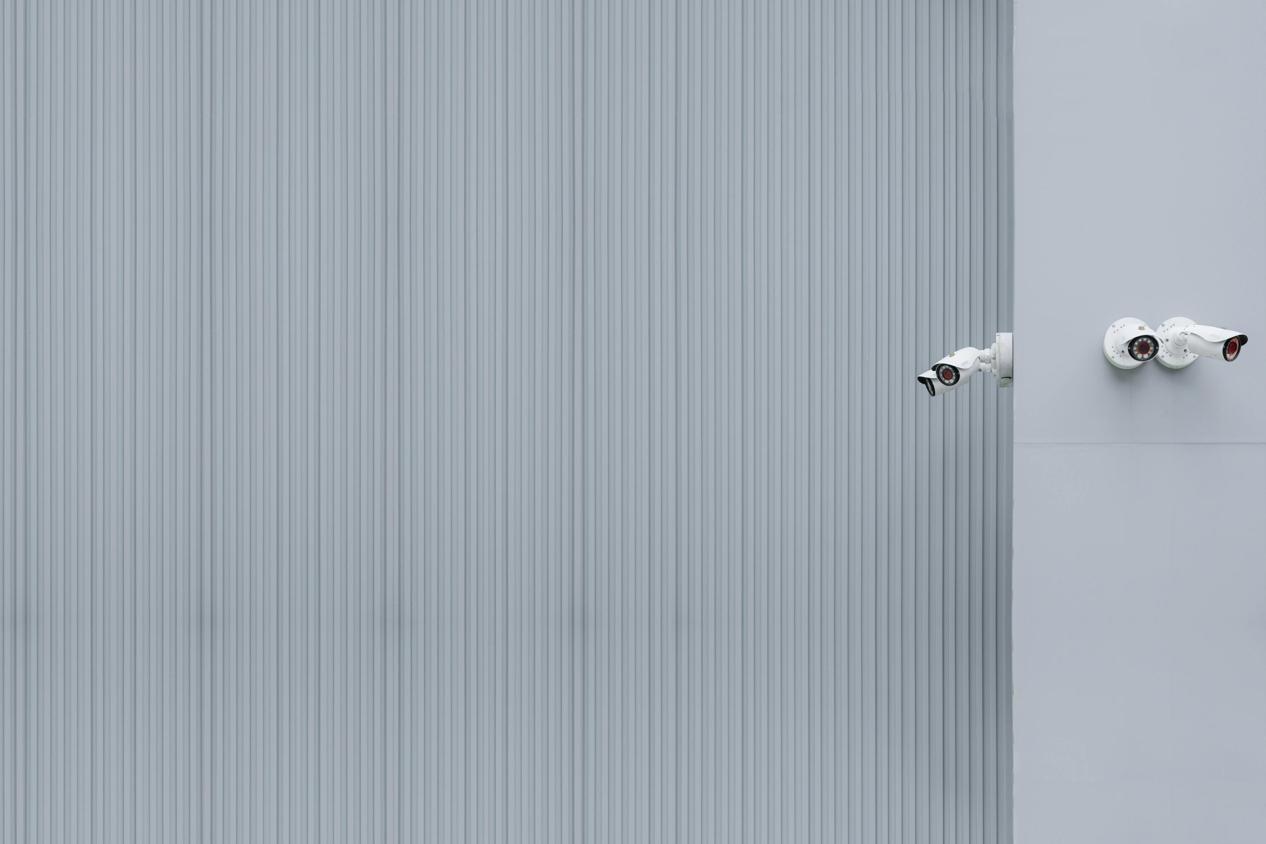 Bullet security cameras installed on a commercial building exterior for perimeter monitoring