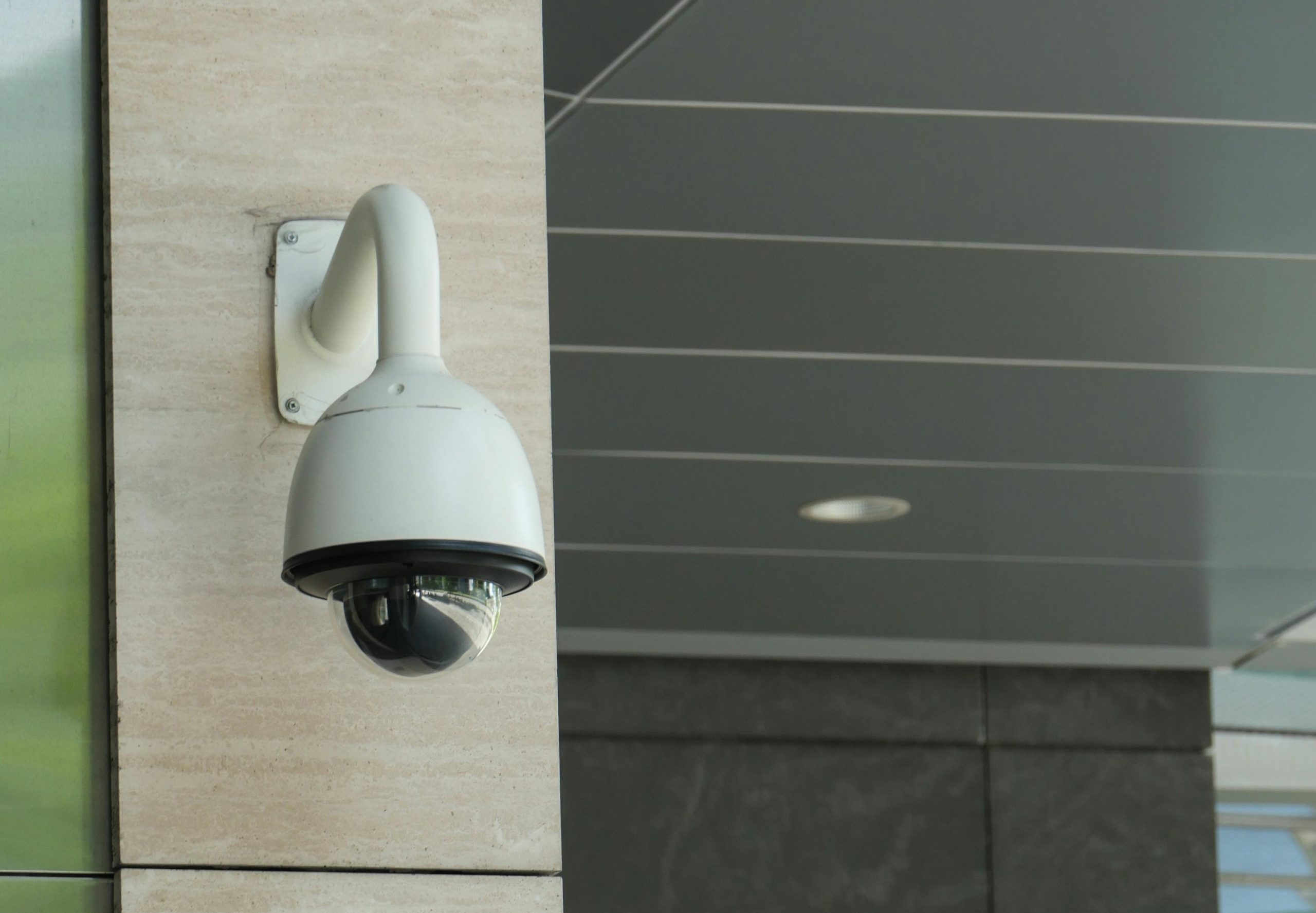 Dome security camera mounted on a commercial building exterior for business surveillance